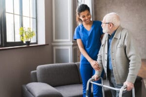 Healthcare worker helps older gentleman